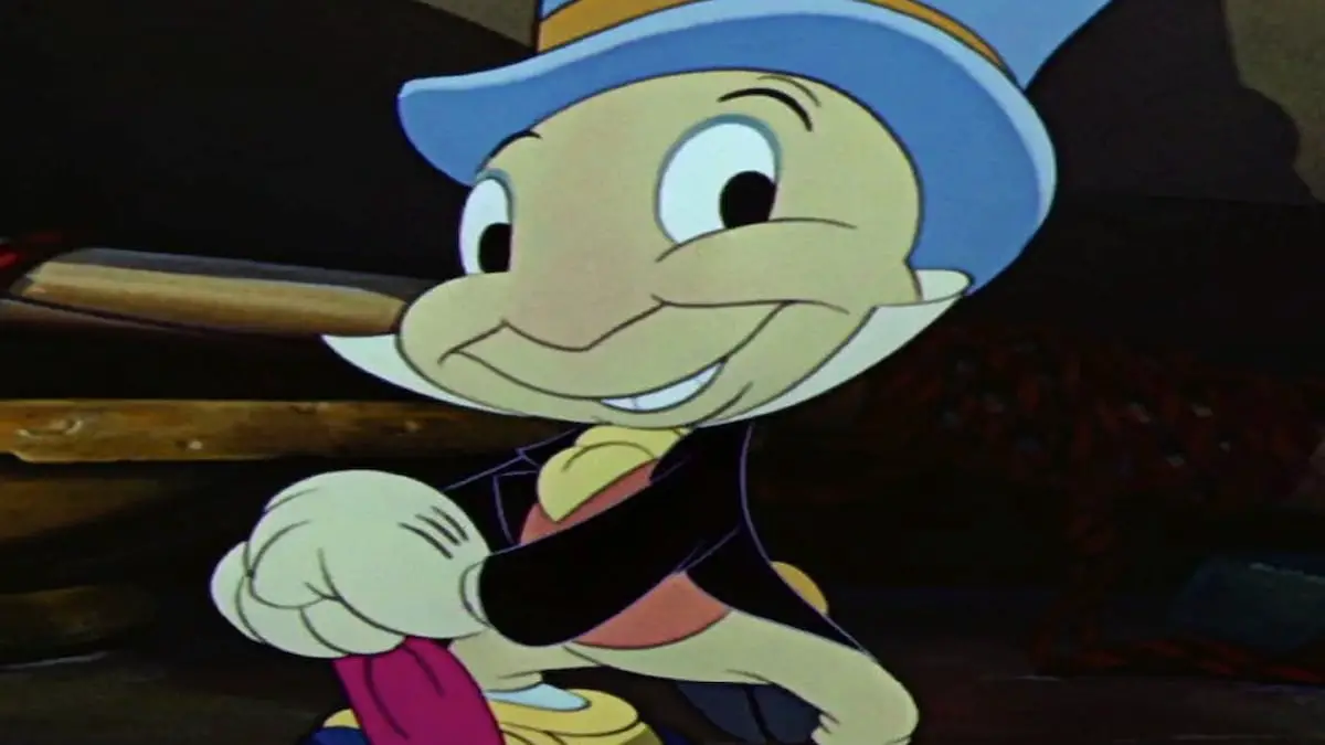 Jiminy Cricket s červeným deštníkem a modrým kloboukem, s úsměvem